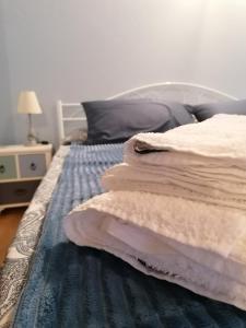 a bed with white blankets and pillows on it at C'era una volta in Castelnuovo Don Bosco