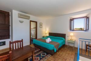 a bedroom with a bed with a stuffed animal on it at Residenza d'Epoca Pietra Di Ponente in Ciampino