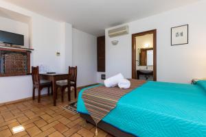 a bedroom with a bed and a table and chairs at Residenza d'Epoca Pietra Di Ponente in Ciampino