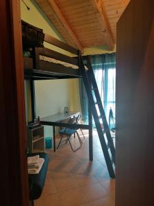 a room with a loft bed and a desk at C'era una volta in Castelnuovo Don Bosco