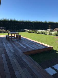 - une table de pique-nique et un banc sur la terrasse dans l'établissement Dunray Cottage - Welcome to Havelock North, à Hastings