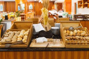 een buffet met brood en zoete deegwaren op een tafel bij Hotel Kompas in Kranjska Gora