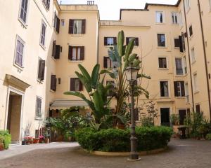 a palm tree in front of a building at Mama House Roma in Rome