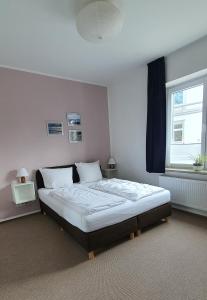 a bedroom with a large bed with a window at Gästehaus bed & kitchen in Schleswig