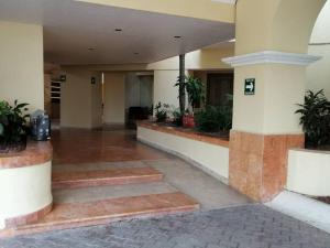 a lobby of a building with potted plants at Paradise apartment, private beach condo Bay View Grand in Puerto Vallarta