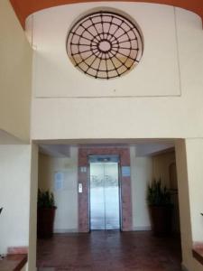 a hallway of a building with a glass door at Paradise apartment, private beach condo Bay View Grand in Puerto Vallarta