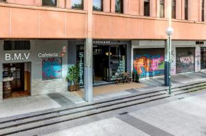 a store front of a building with graffiti on it at Hostal Siesta & Go Nuevos Ministerios in Madrid