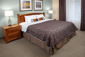 a large bed in a hotel room with two lamps at Sonesta ES Suites Toronto Markham in Markham