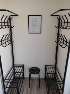 a room with two metal racks and a stool at Ubytování Valentovi in Veľký Meder