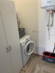 a laundry room with a washing machine and a washer at Ubytování Valentovi in Veľký Meder