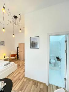 um quarto branco com uma cama e um WC em Apartament Plopilor Studios em Sibiu