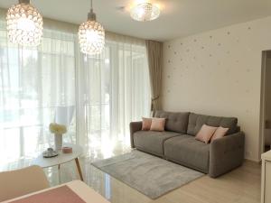 a living room with a couch and a table at Spa Residence Carbona EmDoNa Luxury Apartment in Hévíz