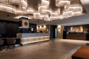 a hotel lobby with a large chandelier at The Executive Inn, Newcastle in Newcastle