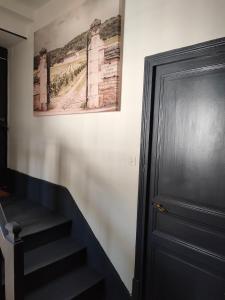 a hallway with a staircase next to a door at Clos Terre-lune in Nuits-Saint-Georges