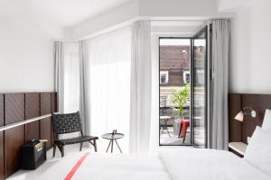 a hotel room with a bed and a balcony at Ruby Claire Hotel Geneva in Geneva