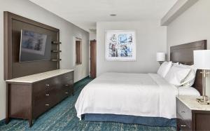 a hotel room with a large bed and a desk at Chelsea Hotel Toronto in Toronto