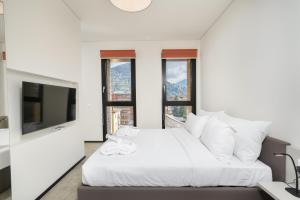 En eller flere senger på et rom på Swiss Hotel Apartments - Lugano