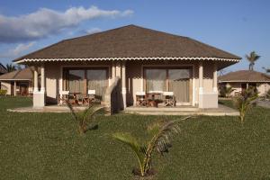 een huis met een tafel en stoelen in het gras bij Ocean Beach Resort & SPA in Malindi