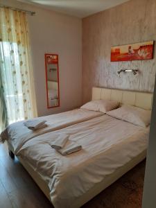 Кровать или кровати в номере Apartman Eden