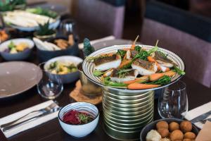 a table with a plate of food on a table at Scandic Gdańsk in Gdańsk