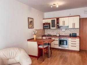 a small kitchen with a table and a chair at Gizela in Luhačovice