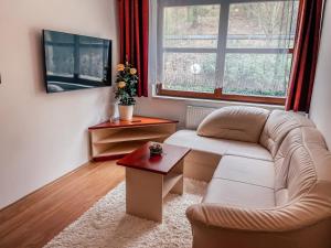 a living room with a couch and a table at Gizela in Luhačovice