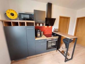 a small kitchen with a counter and a microwave at Wohnambiente in Selb