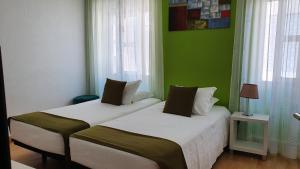 A bed or beds in a room at Hotel Palmeira