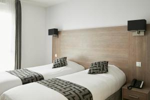 Cama ou camas em um quarto em Tulip Inn Massy Palaiseau - Residence