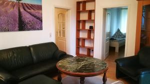 a living room with a couch and a table at Apartment am Südpark in Merseburg