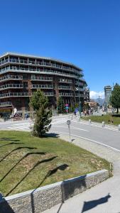 an empty street with a large building in the background at Hotel Cristallo in Sestriere