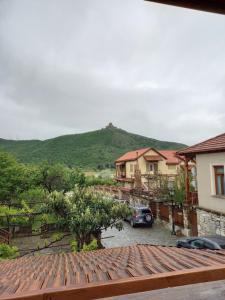 a car parked in a parking lot next to some houses at Levanto in Mtskheta