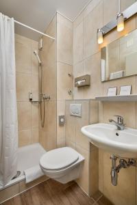 a bathroom with a shower toilet and a sink at Bon Port in Montreux