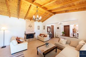 a living room with a couch and a fireplace at Villa Pine Forest in Corfu Town