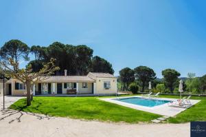 a house with a swimming pool in a yard at Villa Pine Forest in Corfu Town