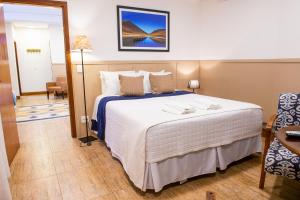 a bedroom with a large bed in a room at Pousada das Lavandas in Campos do Jordão