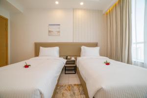 เตียงในห้องที่ Platinum Coast Hotel Apartments