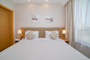 เตียงในห้องที่ Platinum Coast Hotel Apartments