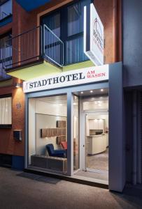 a store front of a building with a sign that reads stratford hotel museum at Stadthotel am Wasen in Stuttgart