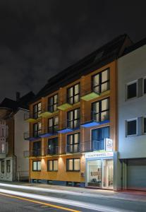 a building on the side of a street at night at Stadthotel am Wasen in Stuttgart