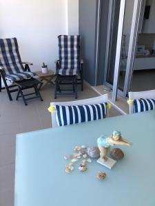 een woonkamer met 2 stoelen en een pop op een tafel bij Sonho do Mar Ap. in Nazaré