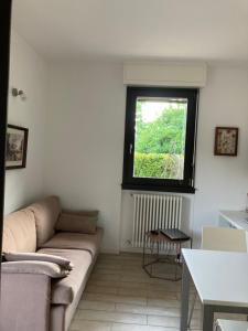 a living room with a couch and a window at Casa Lisa in Lenno