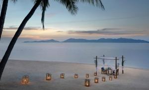 a wedding set up on the beach with lights at Santiburi Koh Samui in Mae Nam