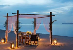 a table set up for a wedding on the beach at Santiburi Koh Samui in Mae Nam