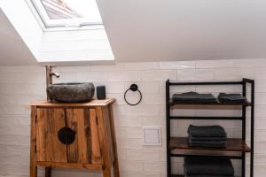 a bathroom with a sink and a skylight at PARKHOUSE in Rožňava