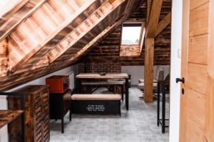 a attic room with a desk and a window at PARKHOUSE in Rožňava