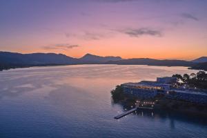 una vista aérea de un complejo sobre el agua al atardecer en Xenia Poros Image Hotel, en Poros