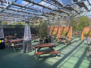 a group of picnic tables under a pergola at The White Swan, Yeadon in Yeadon