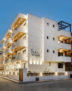 a large white building with a sign on it at Anassa Suites in Leptokaria