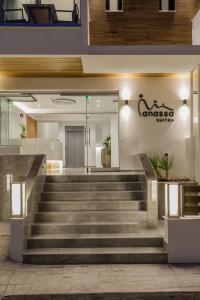 a lobby with stairs in front of a building at Anassa Suites in Leptokaria